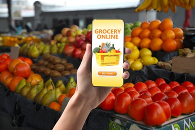 Image of Food delivery. Man using mobile phone app to order grocery online, closeup