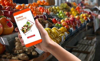 Image of Food delivery. Man using mobile phone app to order grocery online, closeup