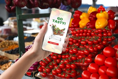 Image of Food delivery. Man using mobile phone app to order grocery online, closeup