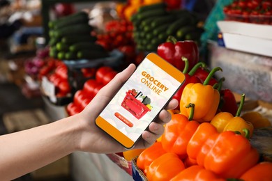 Image of Food delivery. Man using mobile phone app to order grocery online, closeup
