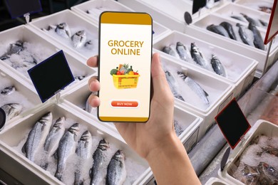 Image of Food delivery. Man using mobile phone app to order grocery online, closeup