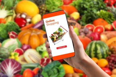 Image of Food delivery. Man using mobile phone app to order grocery online, closeup