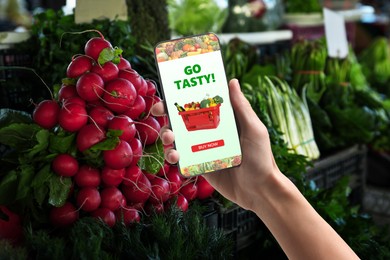 Image of Food delivery. Man using mobile phone app to order grocery online, closeup