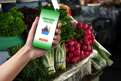 Image of Food delivery. Man using mobile phone app to order grocery online, closeup