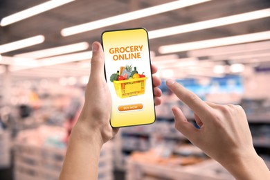 Image of Food delivery. Man using mobile phone app to order grocery online, closeup