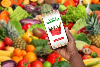 Image of Food delivery. Man using mobile phone app to order grocery online, closeup