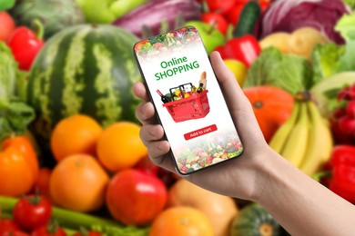Image of Food delivery. Man using mobile phone app to order grocery online, closeup