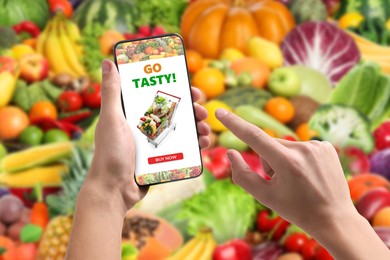 Image of Food delivery. Man using mobile phone app to order grocery online, closeup