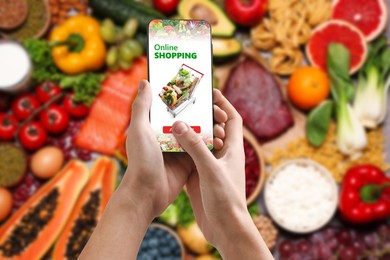Image of Food delivery. Man using mobile phone app to order grocery online, closeup