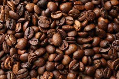 Photo of Aromatic coffee beans as background, top view