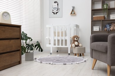 Photo of Baby's room with crib and toys. Interior design