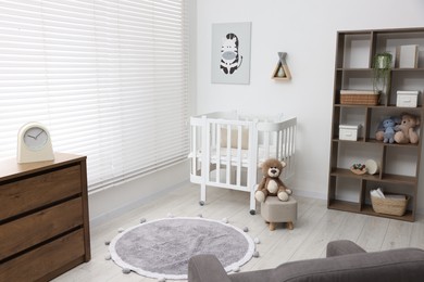 Photo of Baby's room with crib and toys. Interior design