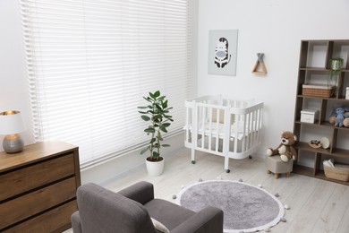 Photo of Baby's room with crib and toys. Interior design