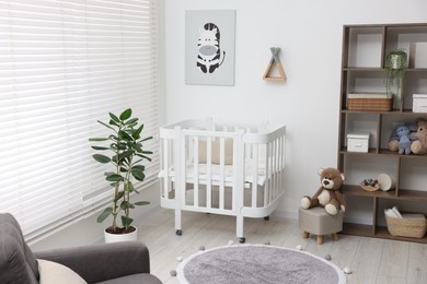 Photo of Baby's room with crib and toys. Interior design