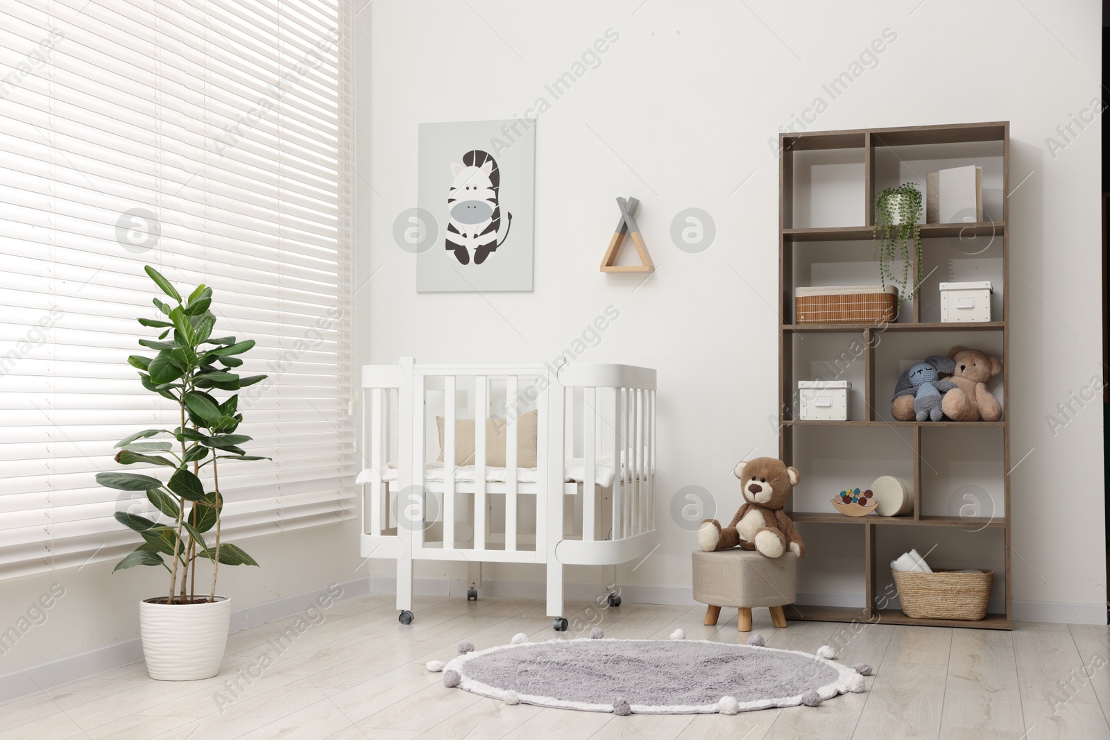 Baby's room with crib and toys. Interior design Photo of Baby's room with crib and toys. Interior design