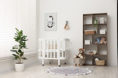 Photo of Baby's room with crib and toys. Interior design