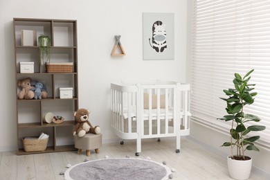 Photo of Baby's room with crib and toys. Interior design