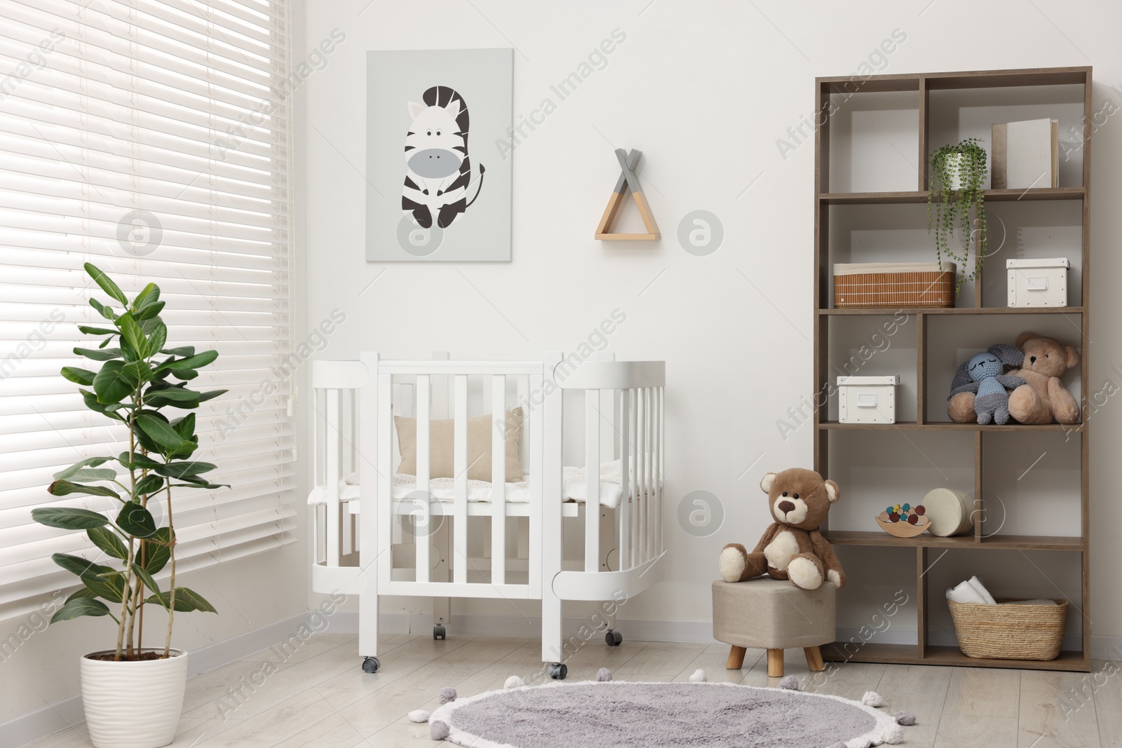 Baby's room with crib and toys. Interior design Photo of Baby's room with crib and toys. Interior design