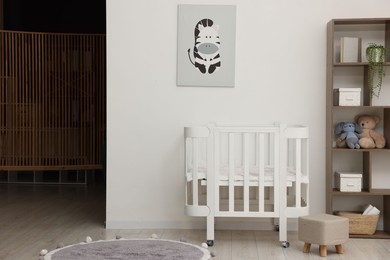 Photo of Baby's room with crib and toys. Interior design