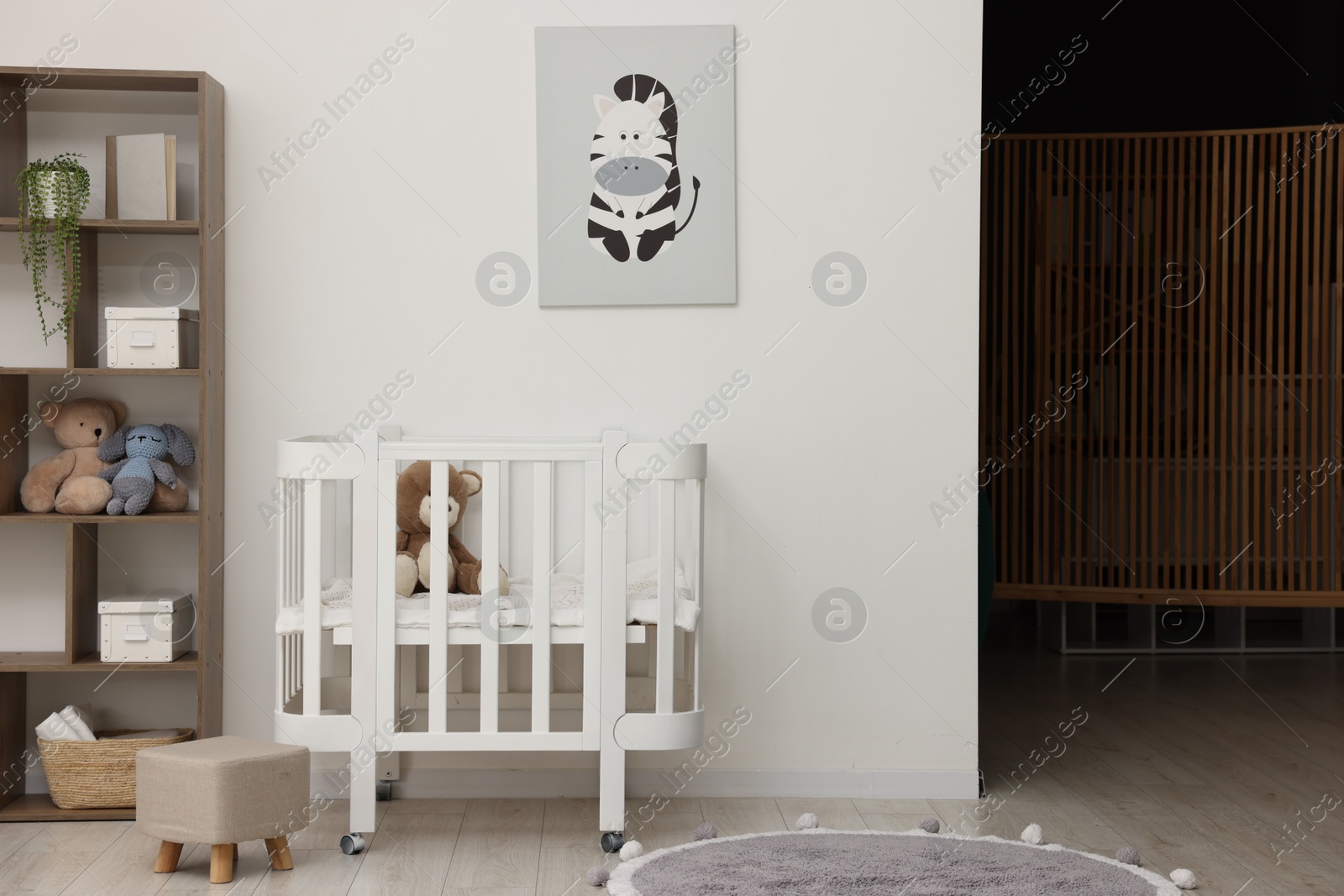 Baby's room with crib and toys. Interior design Photo of Baby's room with crib and toys. Interior design