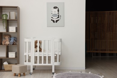 Photo of Baby's room with crib and toys. Interior design