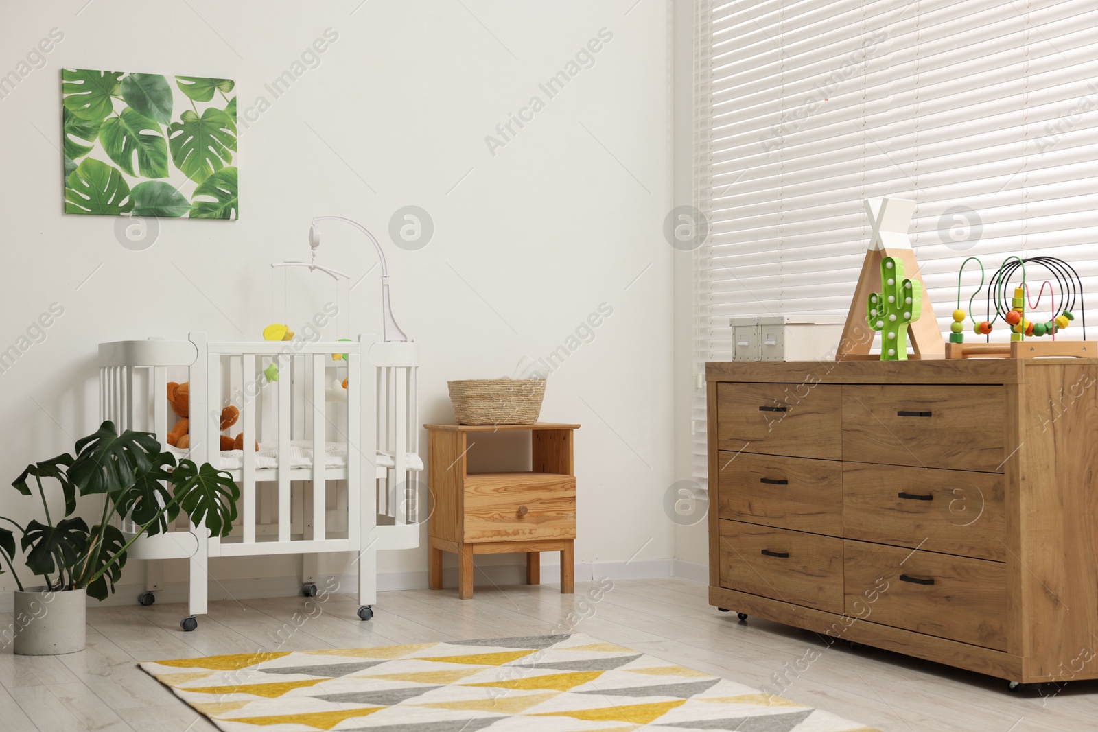 Baby's room with crib and toys. Interior design Photo of Baby's room with crib and toys. Interior design