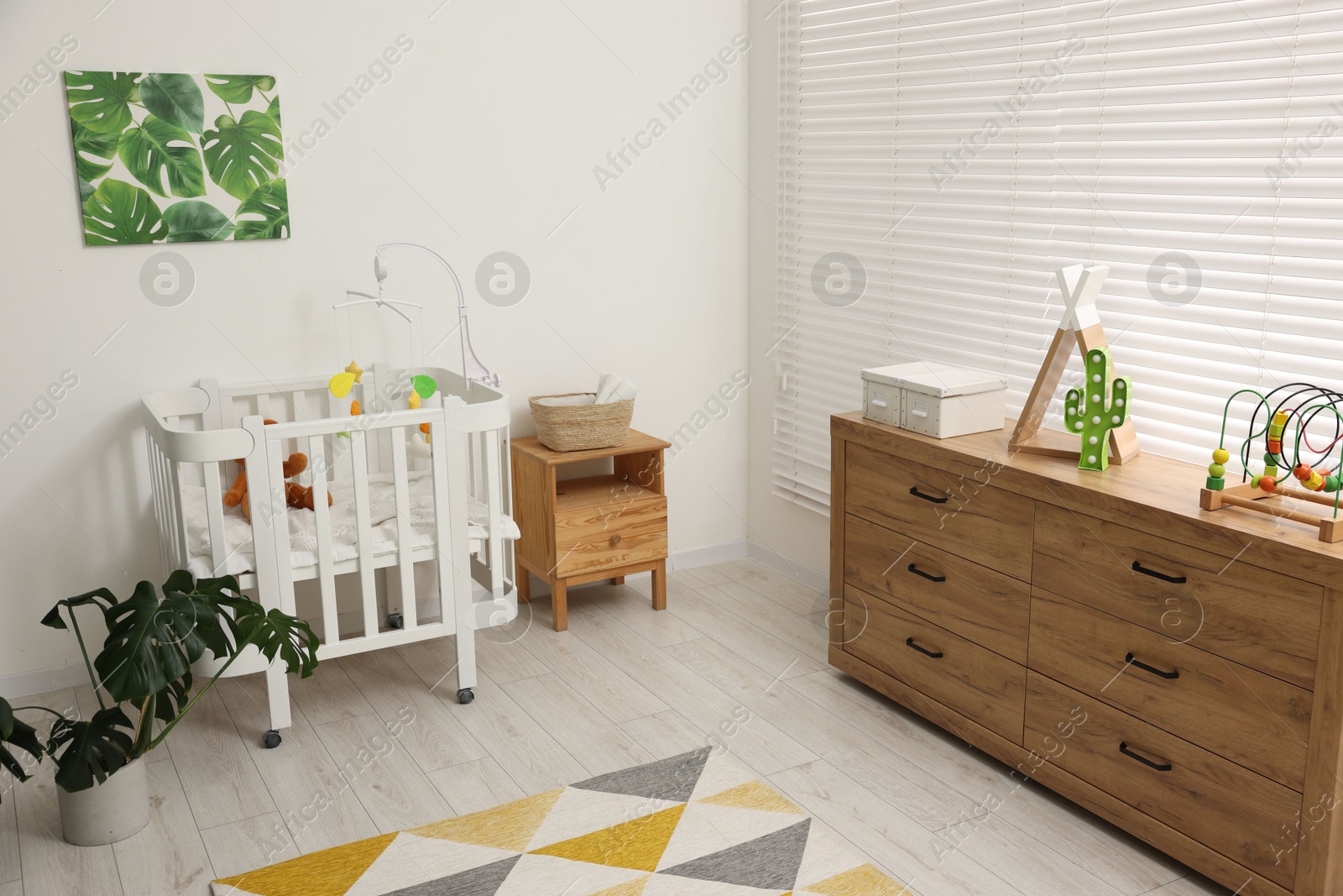 Baby's room with crib and toys. Interior design Photo of Baby's room with crib and toys. Interior design