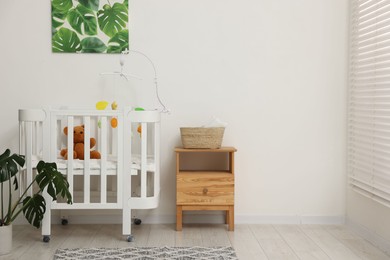Photo of Baby's room with crib and toys. Interior design