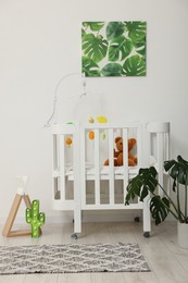 Photo of Baby's room with crib and toys. Interior design