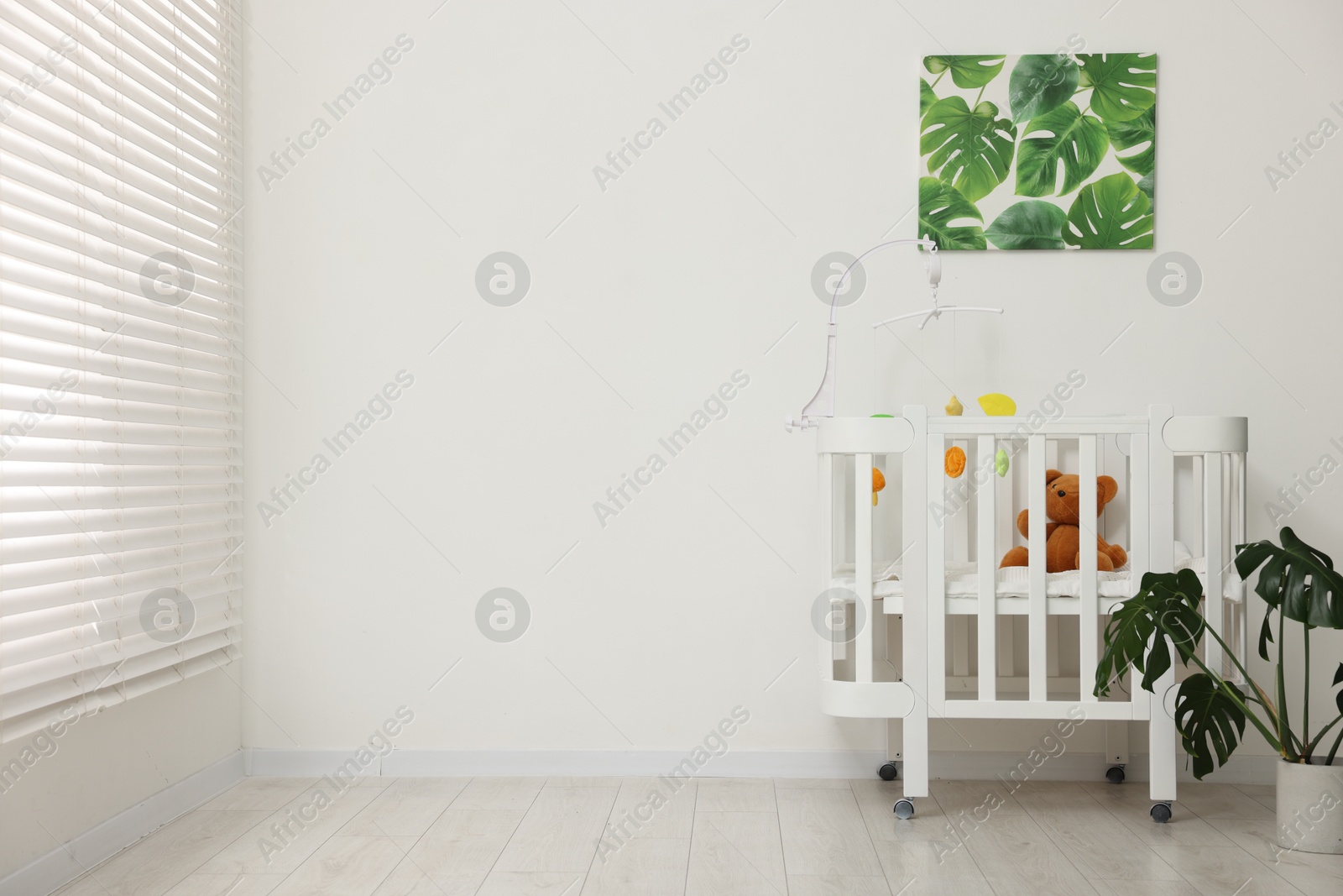 Photo of Baby's room with crib and toys. Interior design