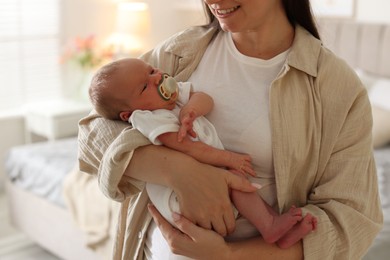 Photo of Mother with her newborn baby at home, closeup