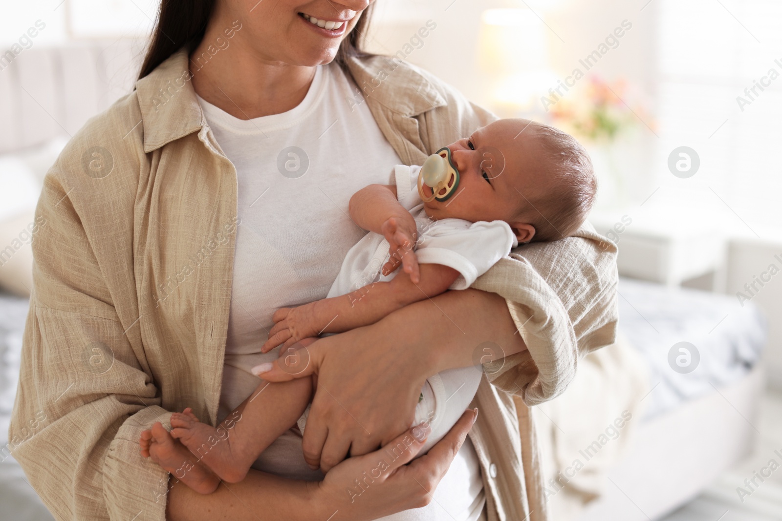 Photo of Mother with her newborn baby at home, closeup