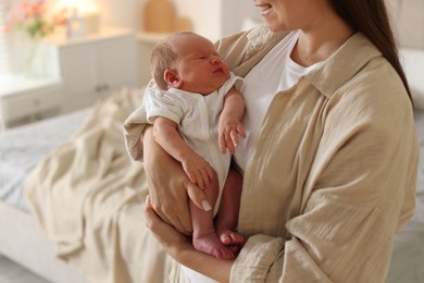 Photo of Mother with her newborn baby at home, closeup