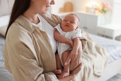 Photo of Mother with her newborn baby at home, closeup