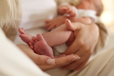 Photo of Mother with her newborn baby at home, closeup