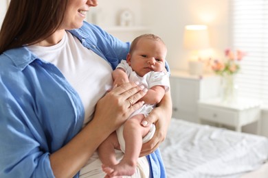 Photo of Mom with her newborn baby at home, closeup