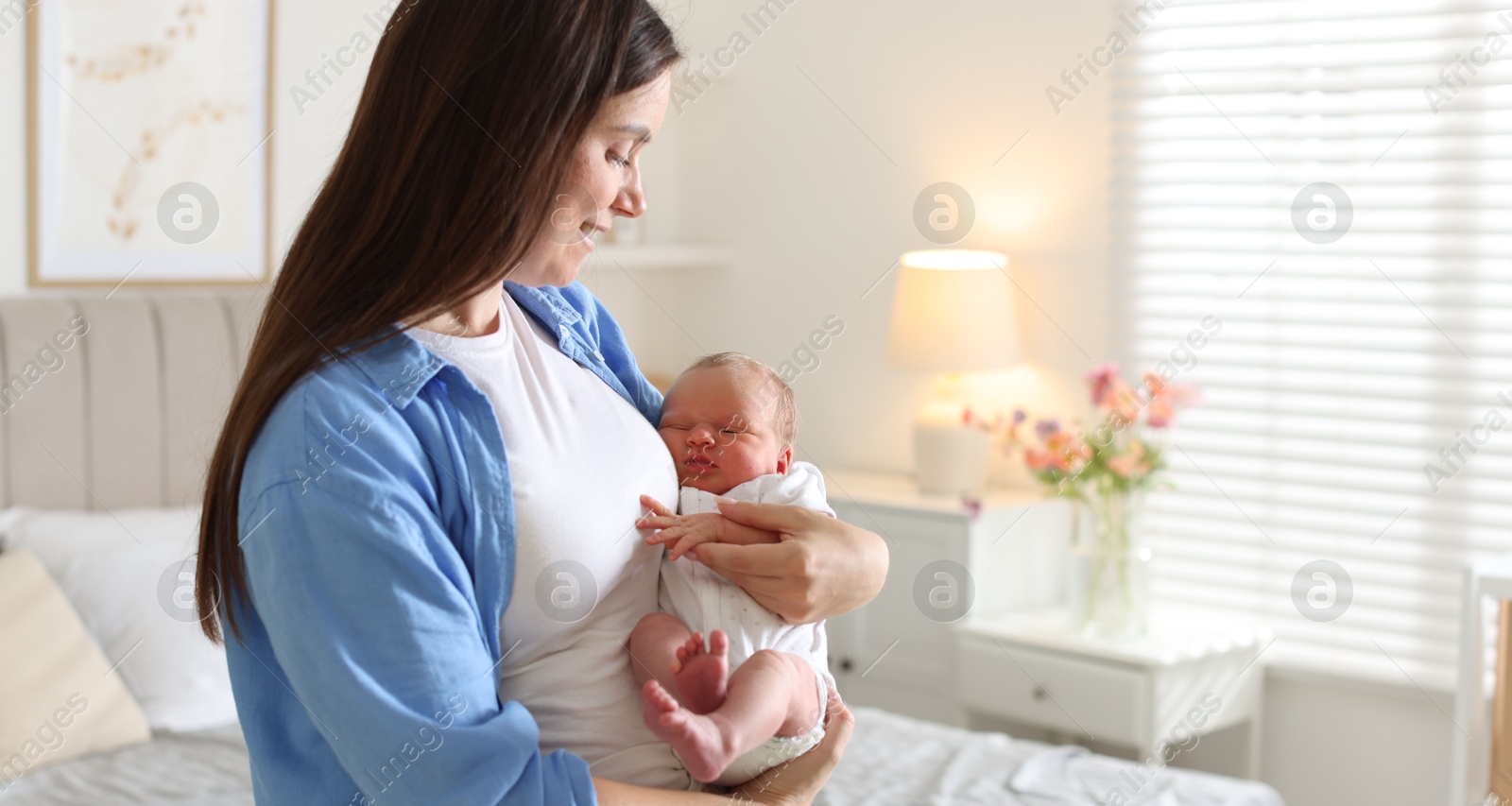 Mom with her newborn baby at home. Space for text Photo of Mom with her newborn baby at home. Space for text