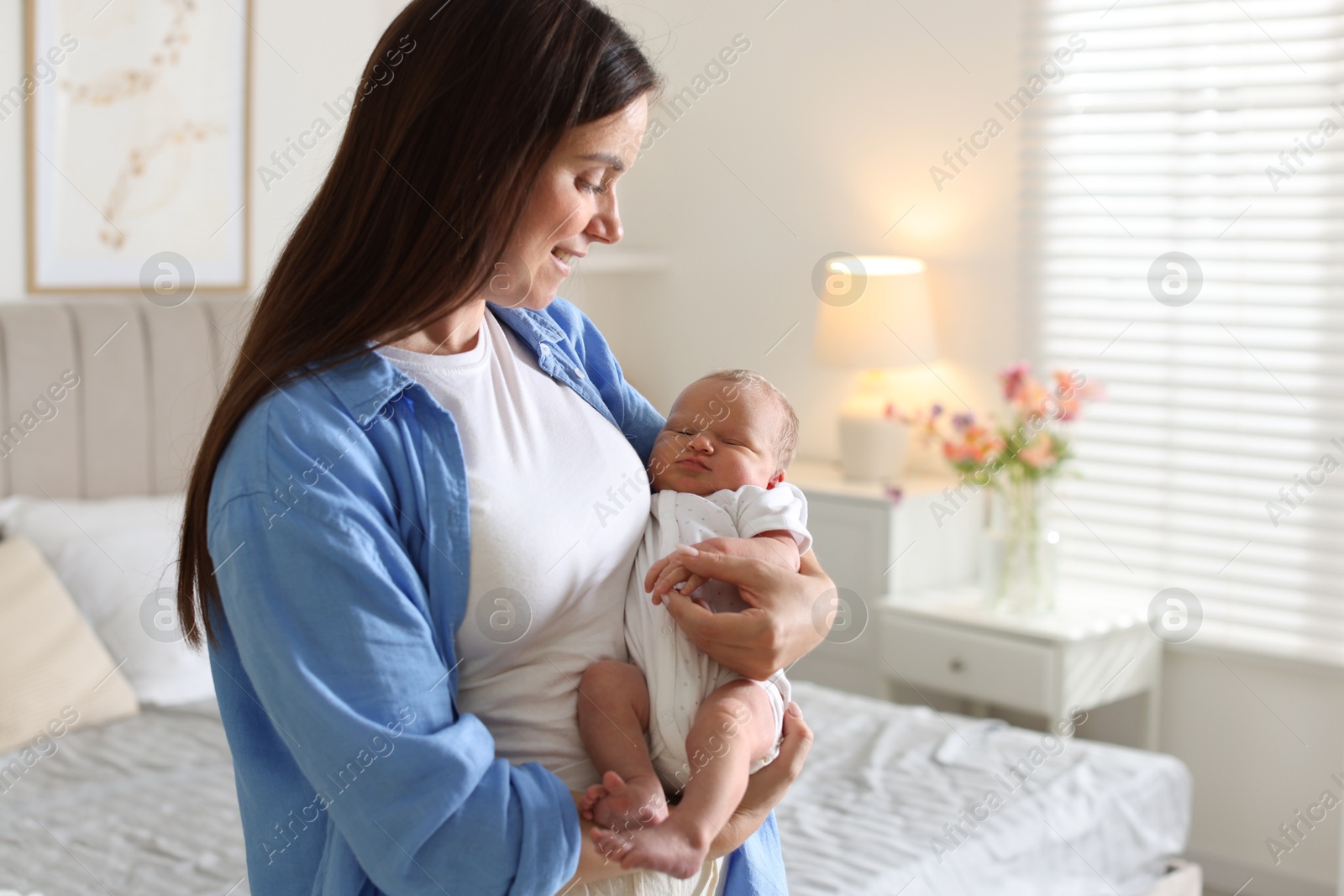 Mom with her newborn baby at home. Space for text Photo of Mom with her newborn baby at home. Space for text