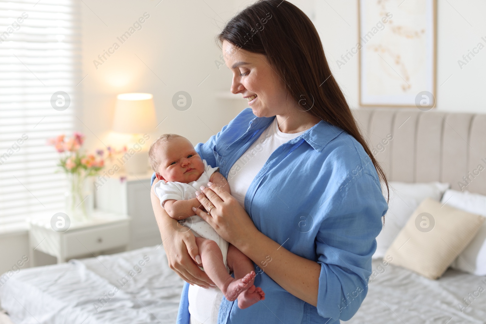 Photo of Mom with her newborn baby at home