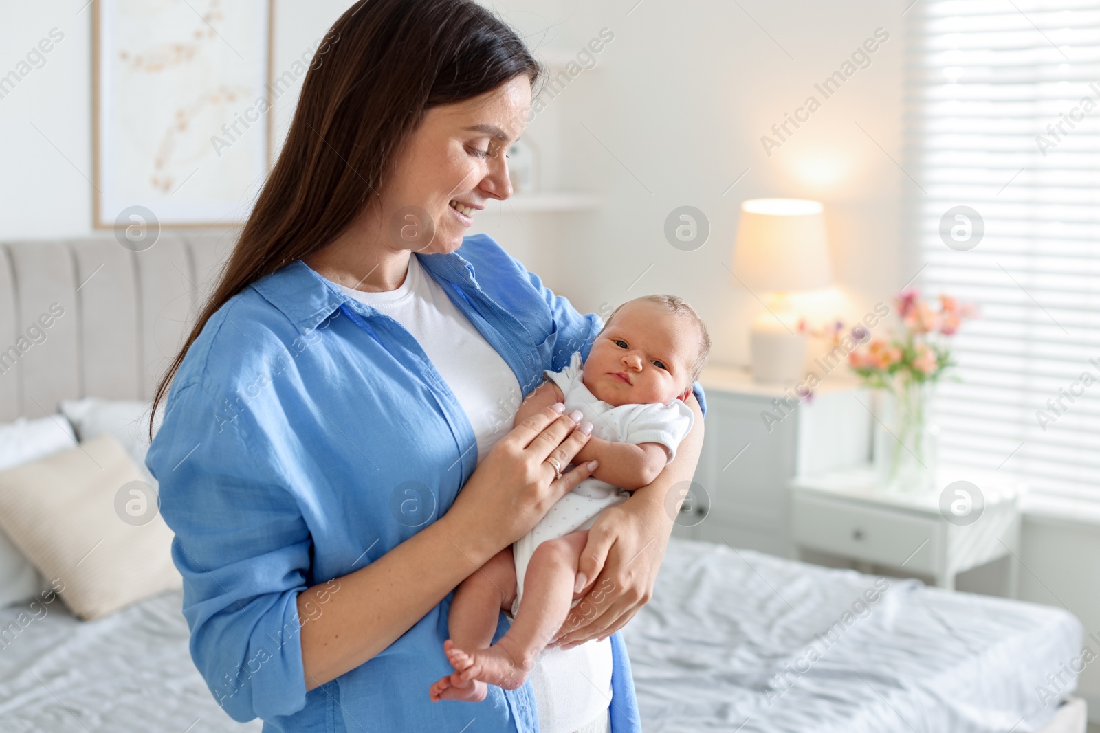 Photo of Mom with her newborn baby at home