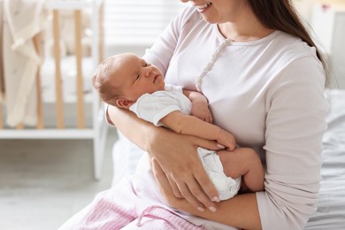 Photo of Mom with her newborn baby at home, closeup