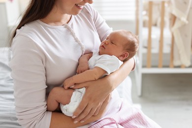 Photo of Mom with her newborn baby at home, closeup