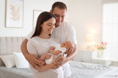 Photo of Happy parents with their newborn baby at home