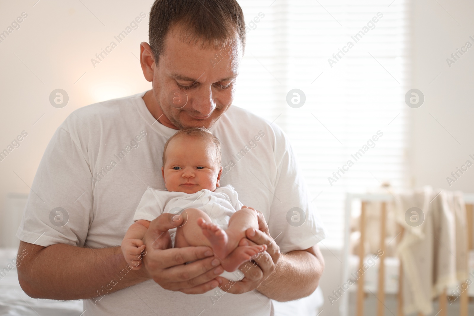 Dad with his newborn baby at home Photo of Dad with his newborn baby at home