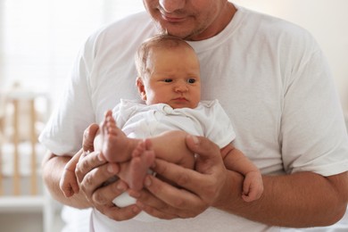 Photo of Dad with his newborn baby at home, closeup