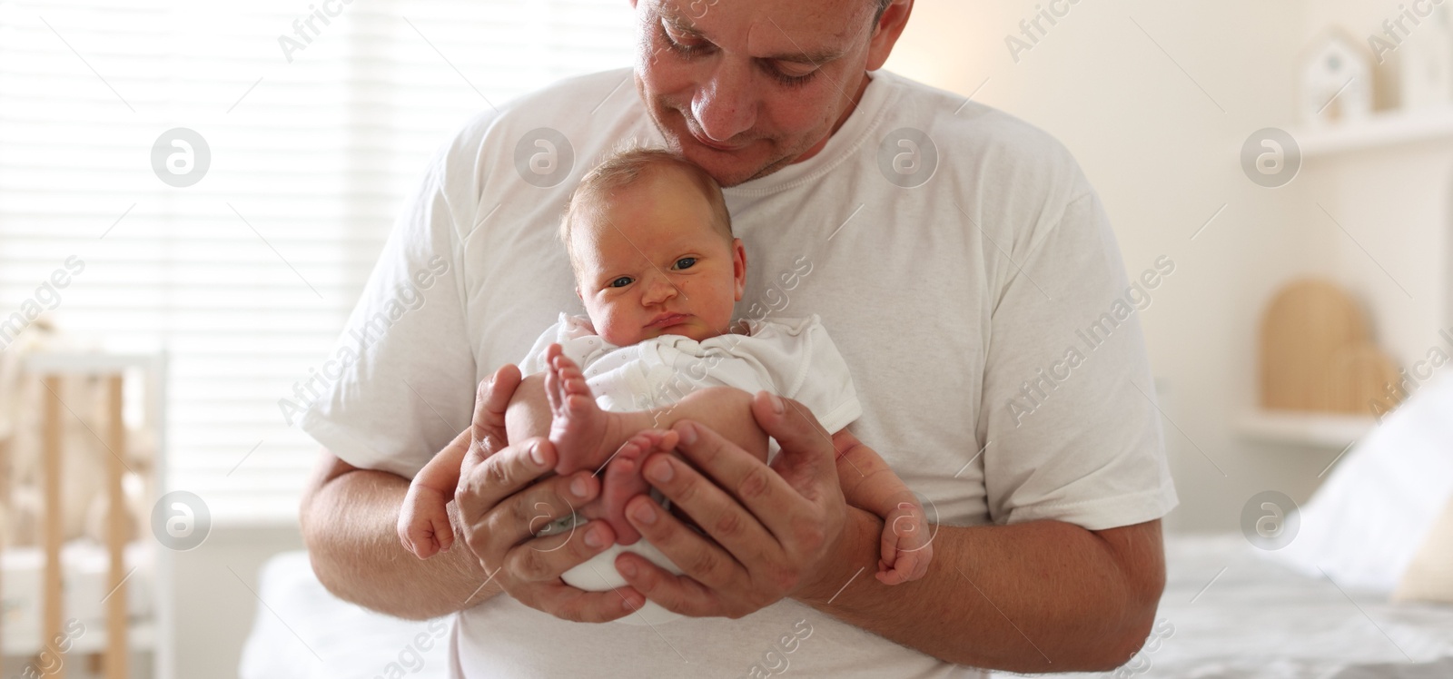 Dad with his newborn baby at home, closeup Photo of Dad with his newborn baby at home, closeup