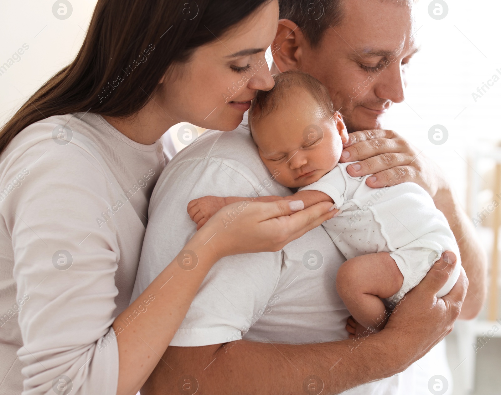 Mother and father with their newborn baby at home Photo of Mother and father with their newborn baby at home