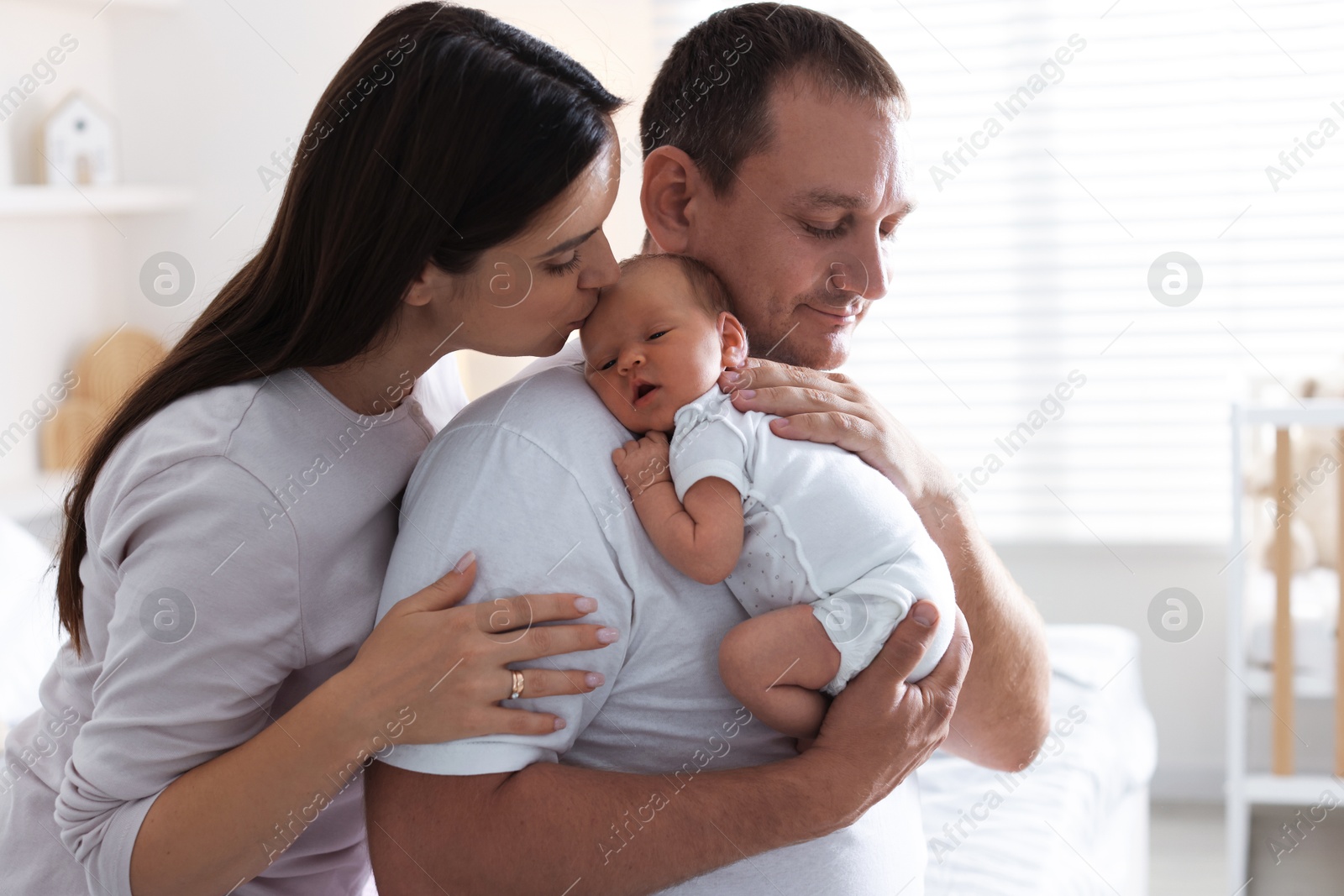 Mother and father with their newborn baby at home Photo of Mother and father with their newborn baby at home