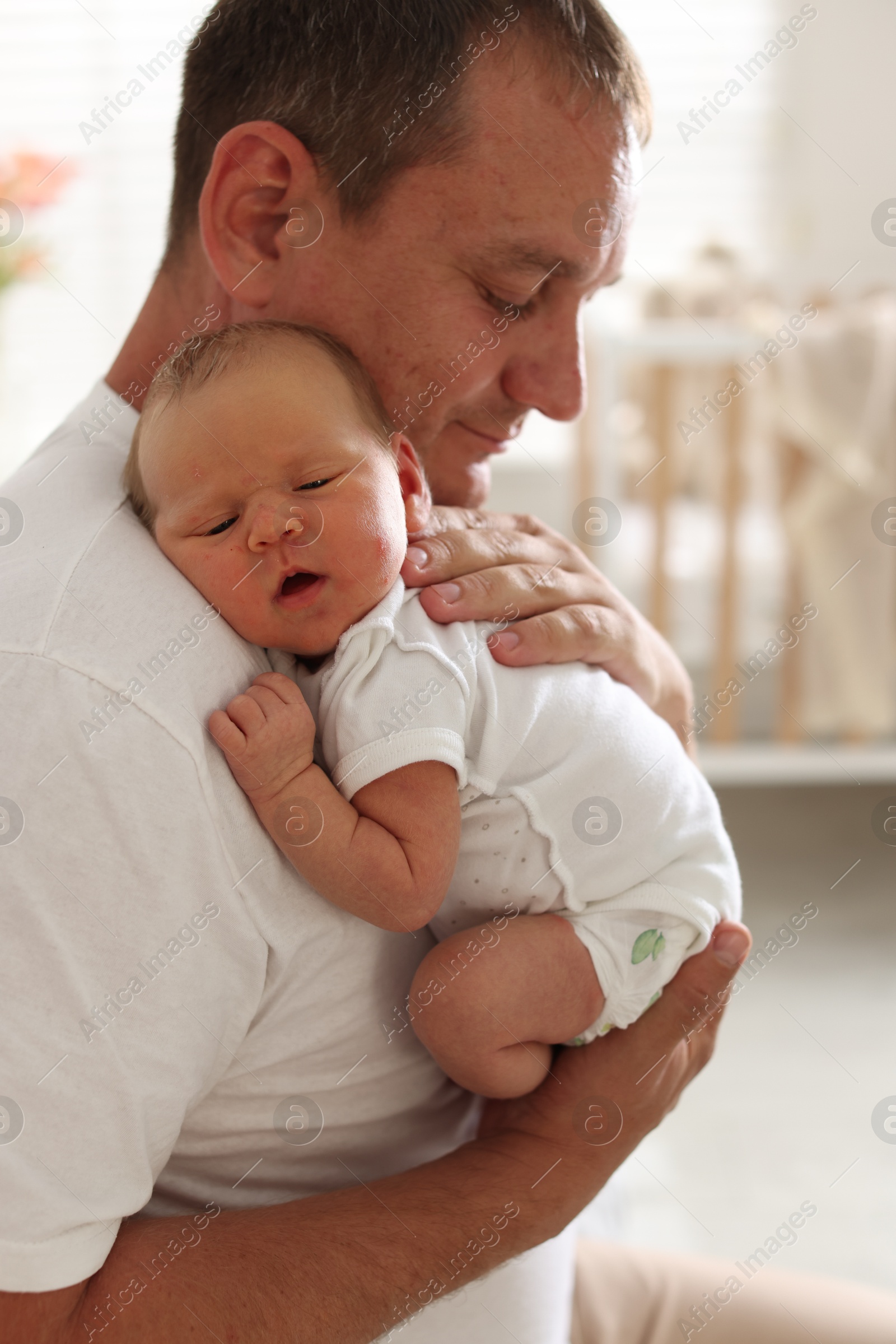 Father with his newborn baby at home Photo of Father with his newborn baby at home