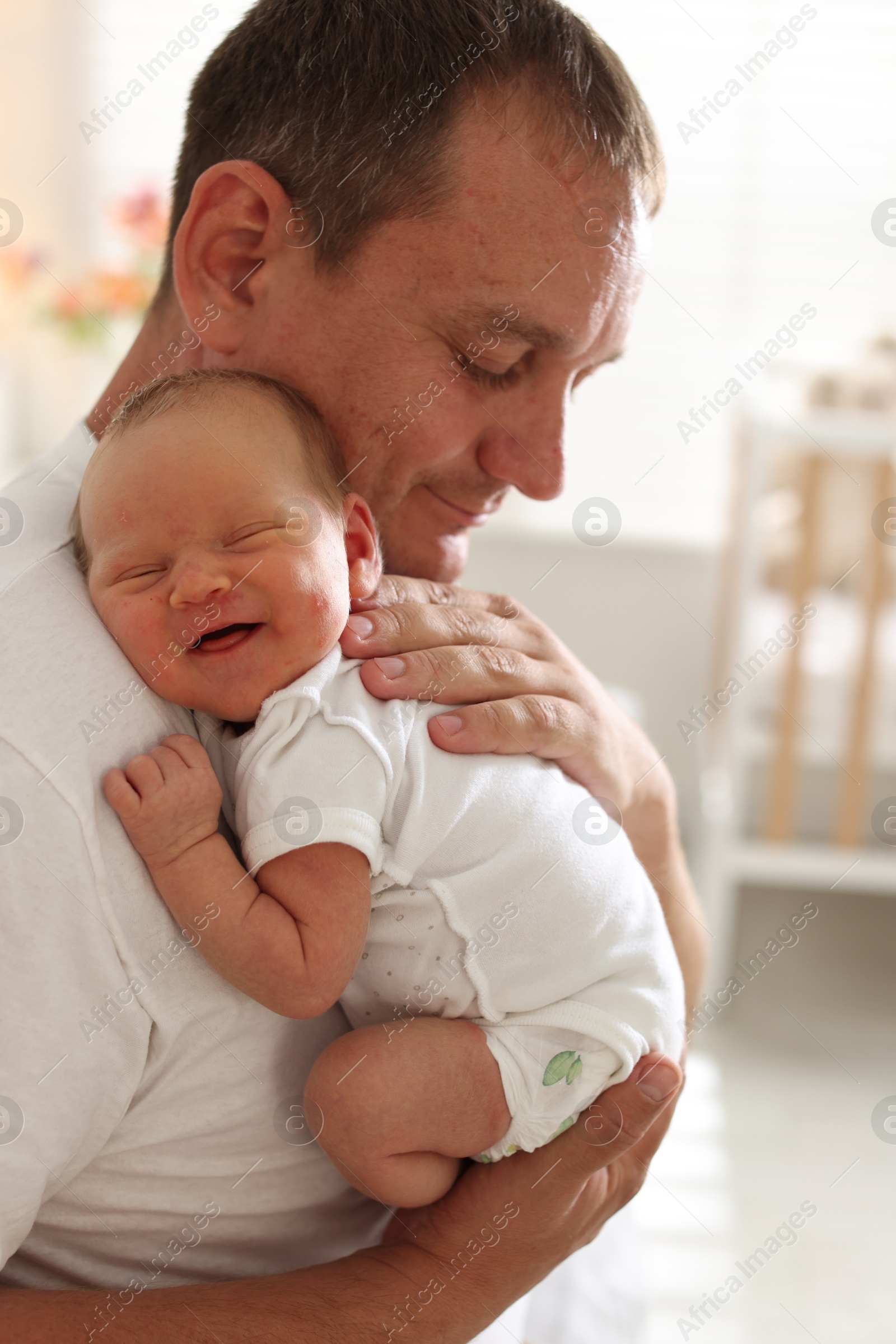 Father with his newborn baby at home Photo of Father with his newborn baby at home
